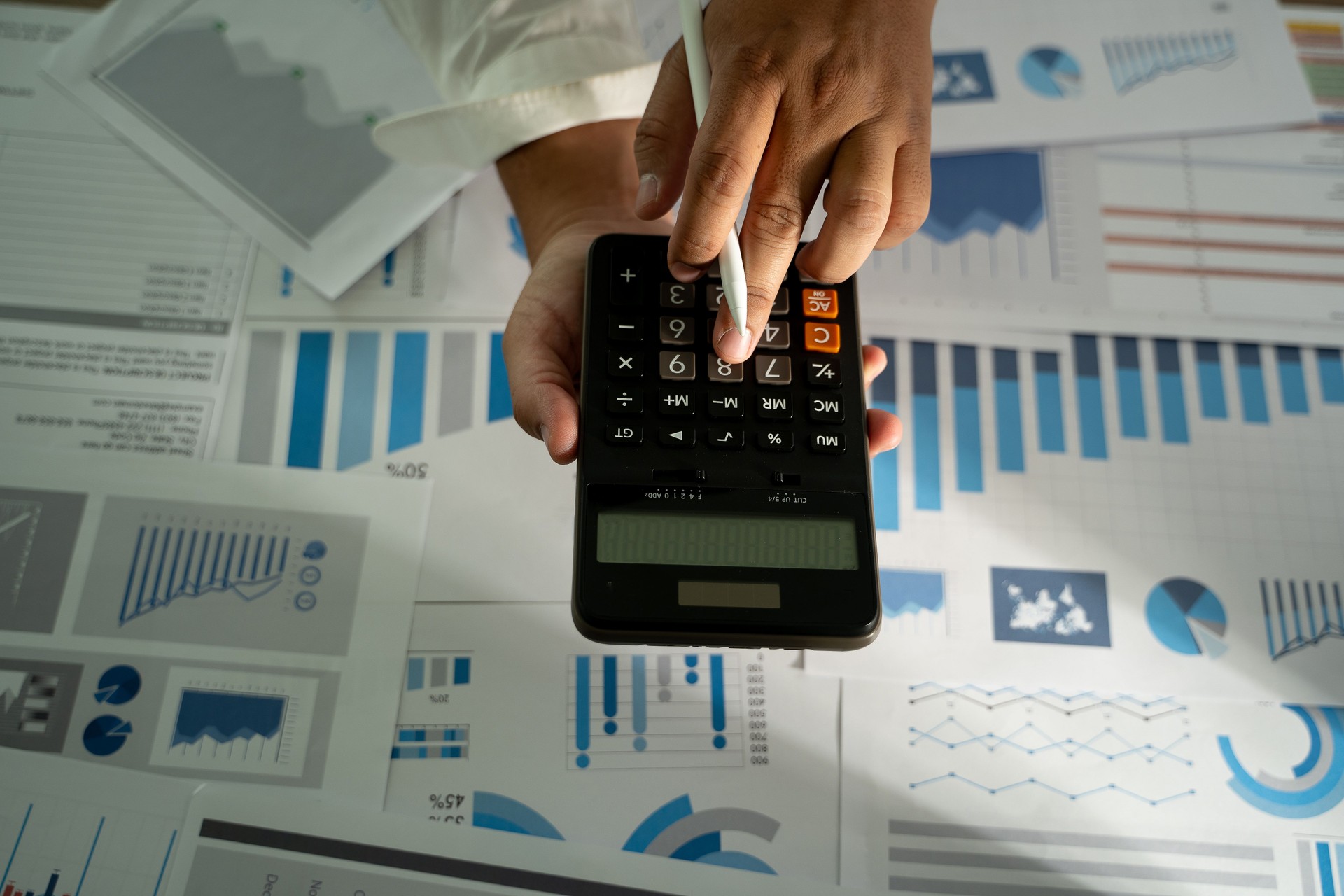 man hand using calculator finance budgeting and tax Financial cost calculation statistical data analysis